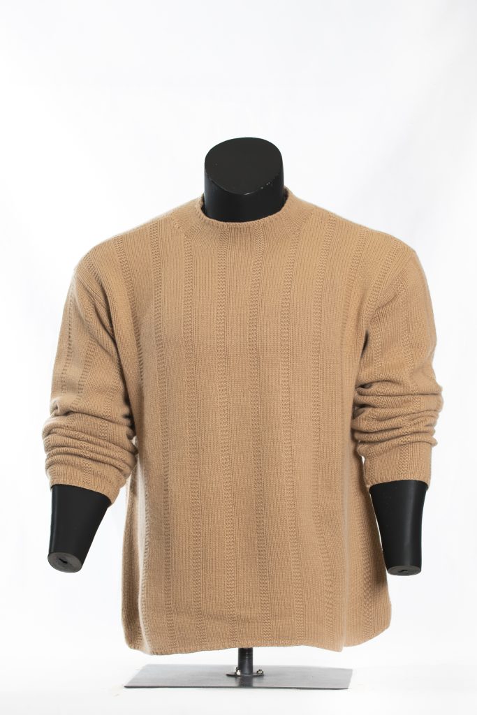 Camel textured roll-neck knit sweater shown from the front on a black mannequin