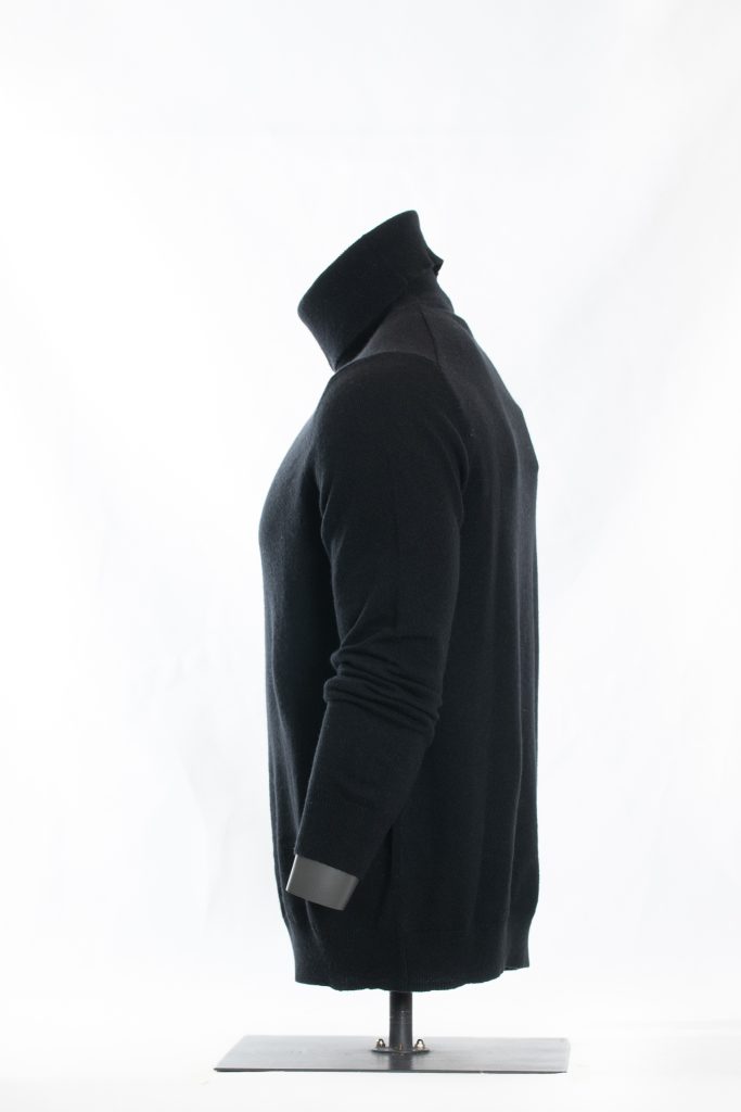 Front view of midnight black roll-neck sweater on a black mannequin