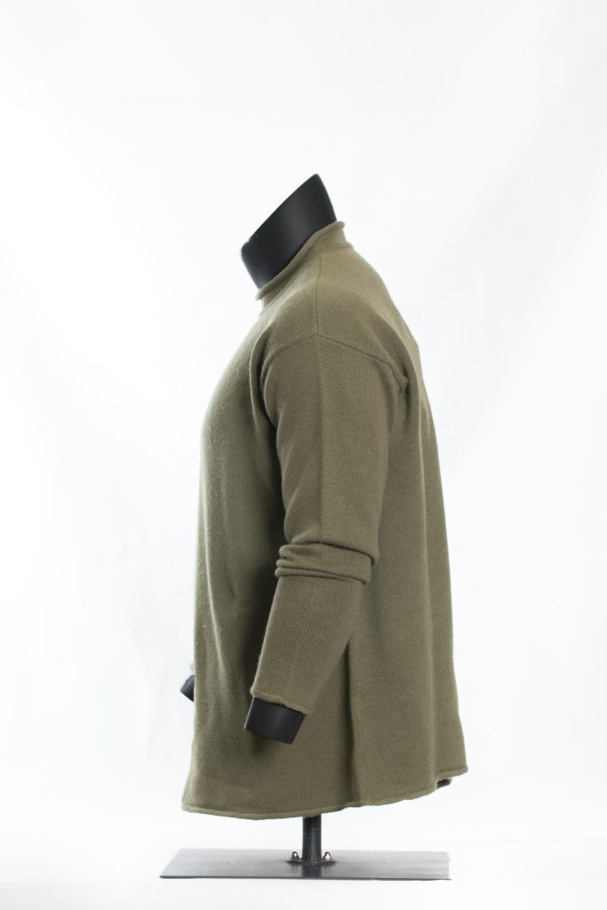 Side view of olive green roll-neck sweater on black mannequin